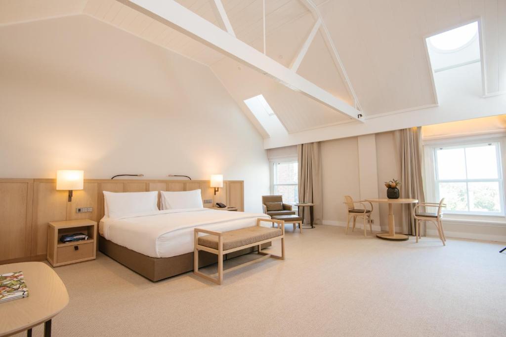 a hotel room with a bed and a table at COMO The Treasury in Perth