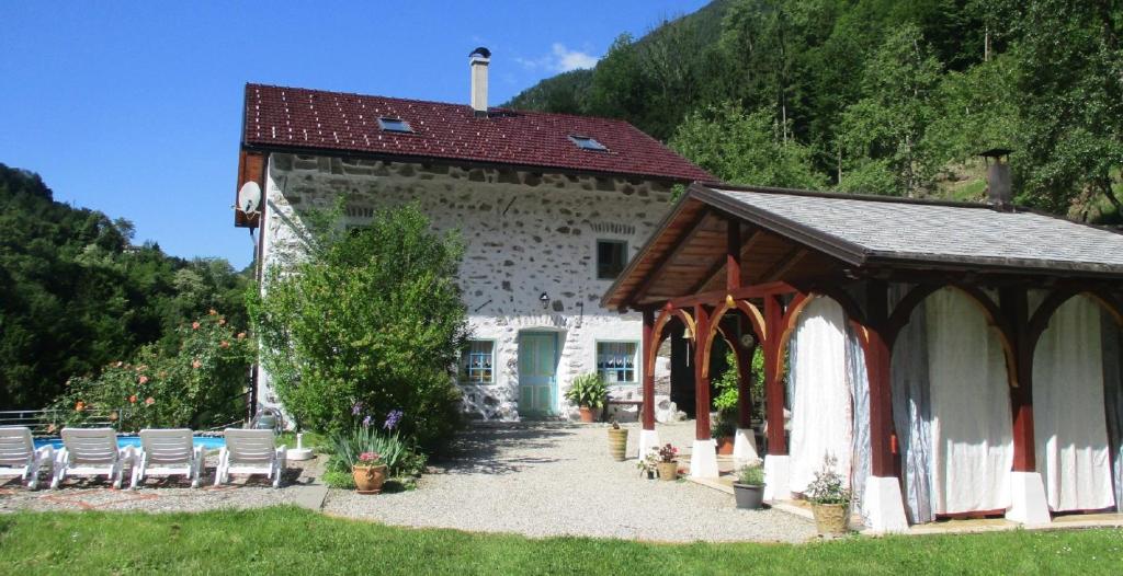 a building with a group of chairs in front of it at Pri Maku in Tolmin