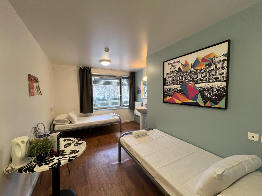 a living room with a couch and a table at St Christopher's Inn Paris - Canal in Paris
