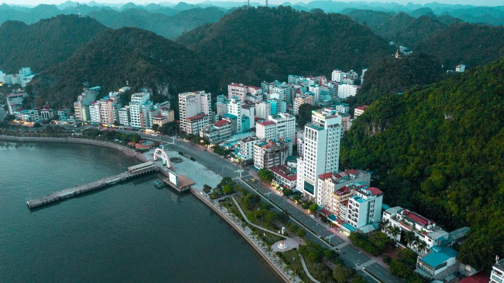 an aerial view of a city with a bridge over the water at Cat Ba 168 Homestay in Cat Ba