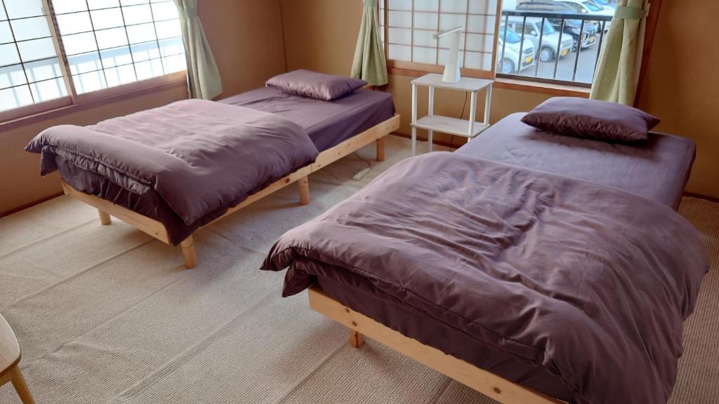 Postel nebo postele na pokoji v ubytování ゲストハウス あずも GuestHouse AZMO