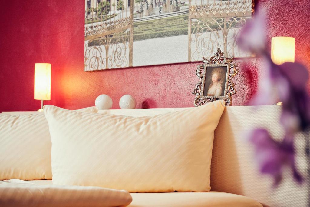 um quarto com uma cama branca e uma parede rosa em Alte Schlossbrauerei em Mirow