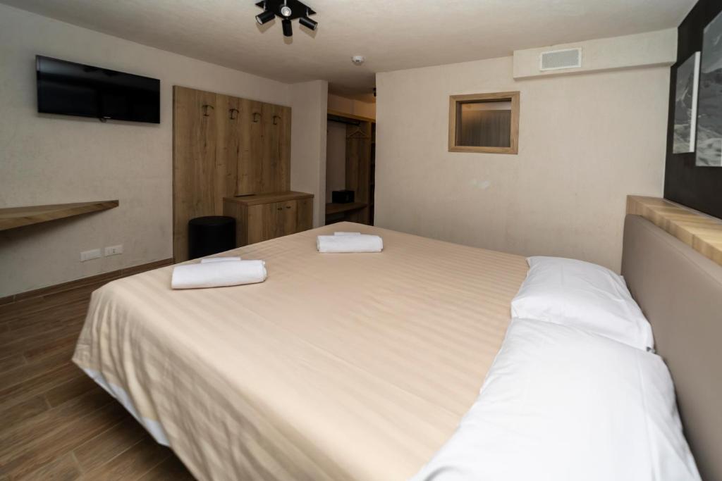 Postel nebo postele na pokoji v ubytování Hotel Petit Palais