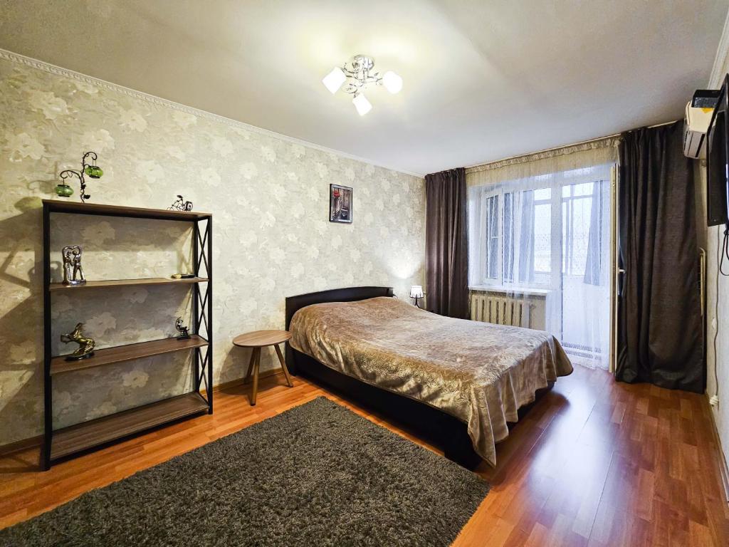 a bedroom with a bed and a window at Nadezhda Apartments on Gogol st. - Maulenov st. in Almaty