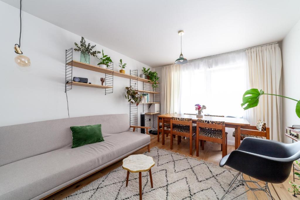 a living room with a couch and a table at Beautifully renovated 1BR Flat in Walthamstow in London