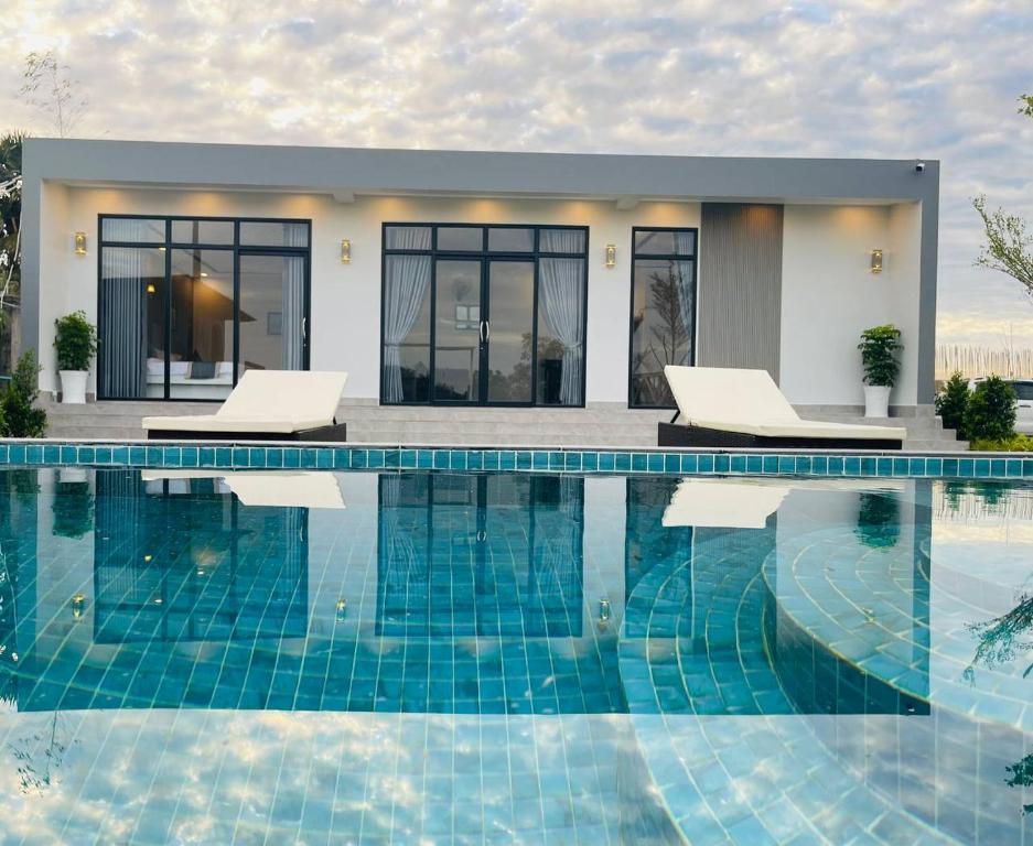 Villa con piscina frente a una casa en The Square Residence en Kampot