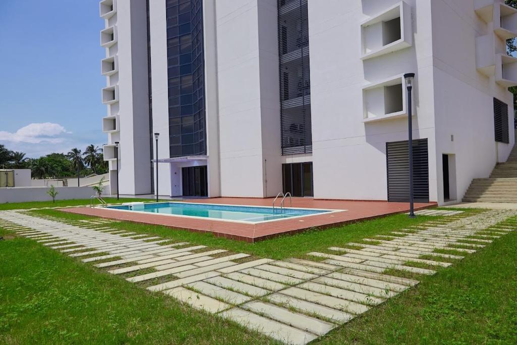 a swimming pool in front of a building at Luxurious Penthouse With Luxurious Pool in Sekondi-Takoradi