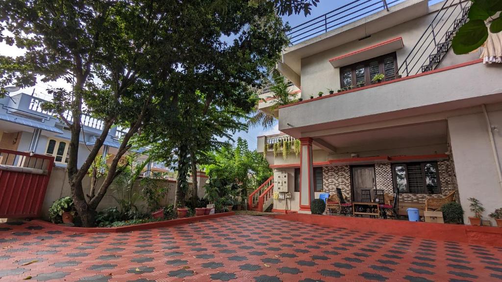 a courtyard of a house with a building at Delight Homestays Coorg in Kushālnagar