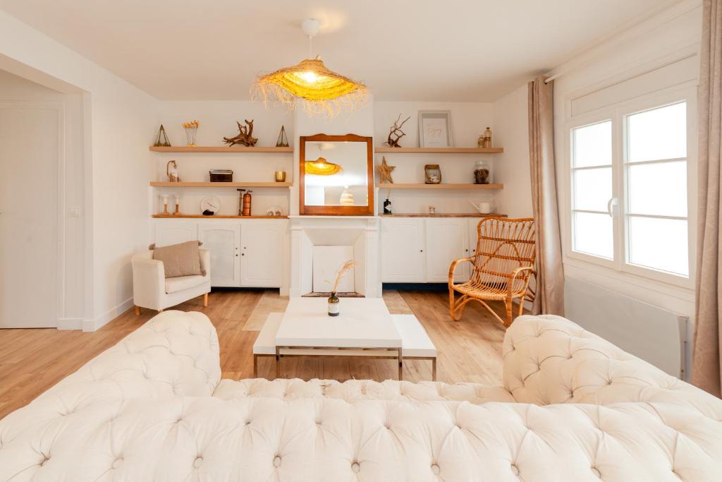 a living room with a white couch and a table at Villa La Mer - 600m de la plage Mesnil Val in Criel-sur-Mer