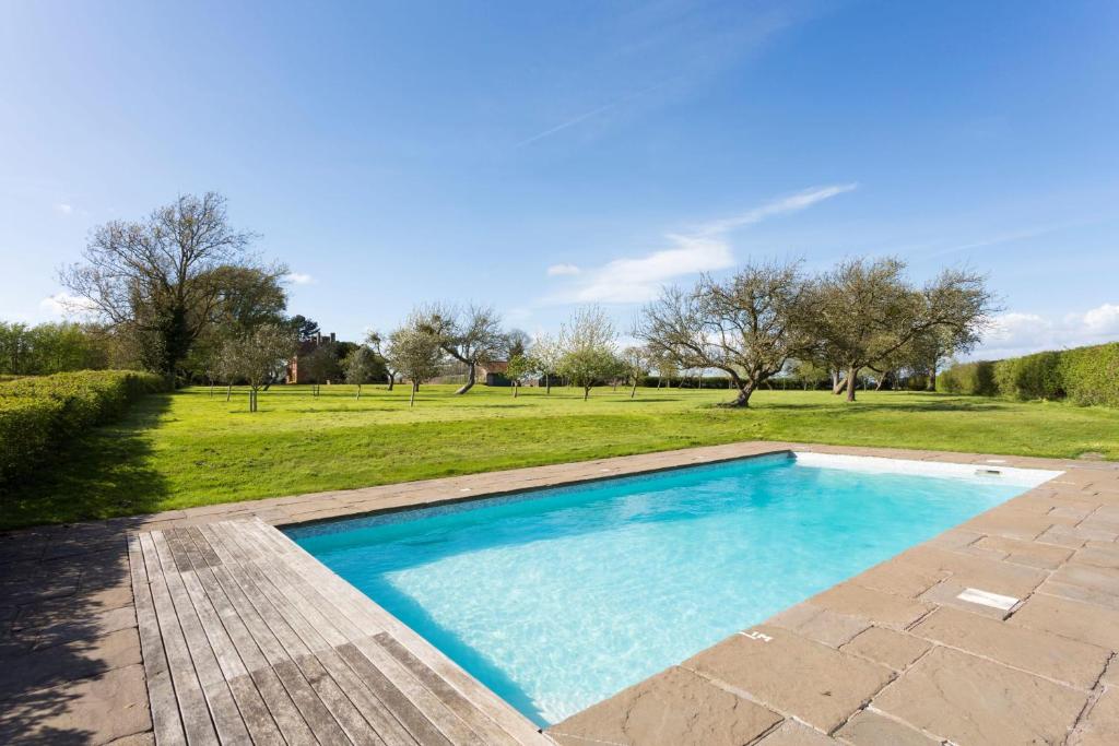 a swimming pool in a park with a grass field at The Old Rectory in Bristol