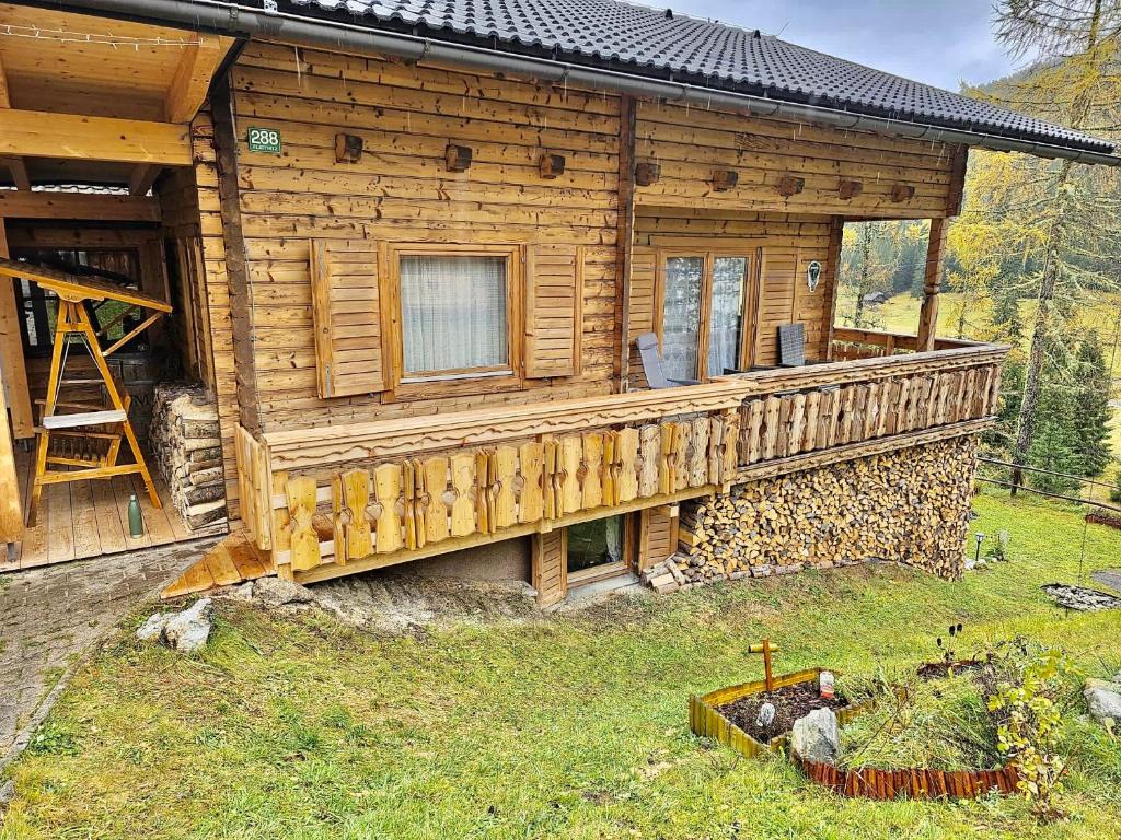 a log cabin with a porch and a deck at Almhaus Zirbenheim Nicolina in Flattnitz