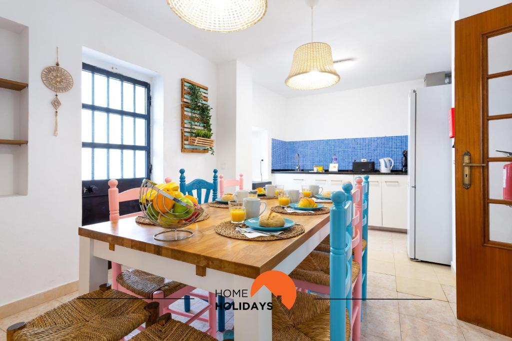 a kitchen and dining room with a table with food on it at #197 Casa Gili by Home Holidays in Albufeira