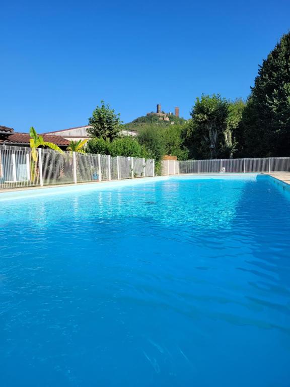 a large swimming pool with blue water at Camping Le Soulhol in Saint-Céré
