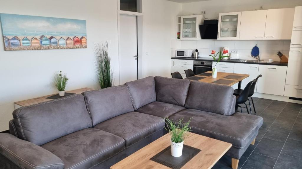 a living room with a couch and a table at Park-Apartment Scharmützelsee Wohnung 7 in Wendisch Rietz