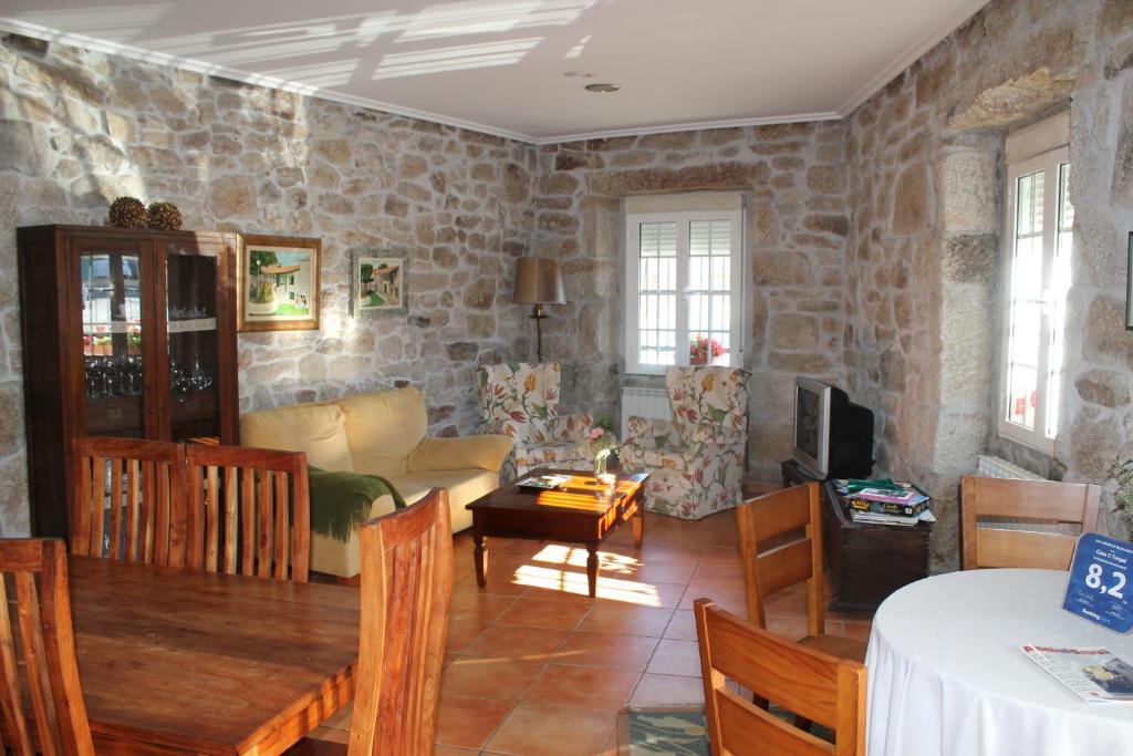 a living room with a stone wall at Casa O Torgal in Parada del Sil