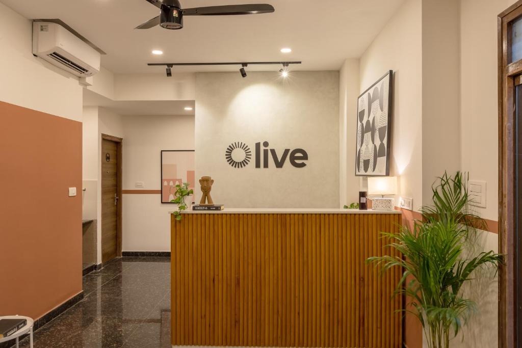 a lobby with a reception desk in a building at Olive Domlur - by Embassy Group in Bangalore