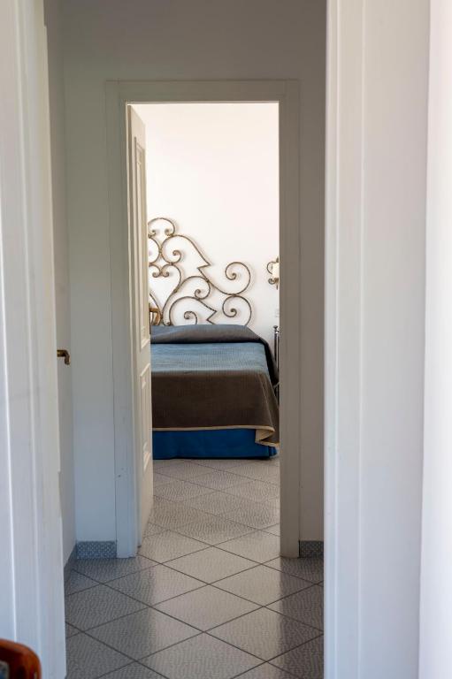 a bedroom with a bed through a doorway at Palatium Mari in Capri