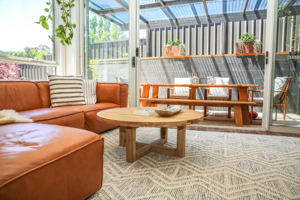 a living room with a couch and a table at Hidden Gem in Bright