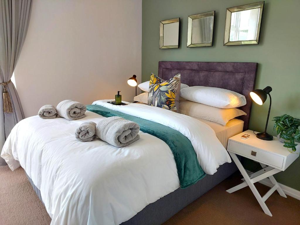 Dos camas en un dormitorio con toallas. en Brizzy's Balcony A Well-located Luxe Retreat, en South End