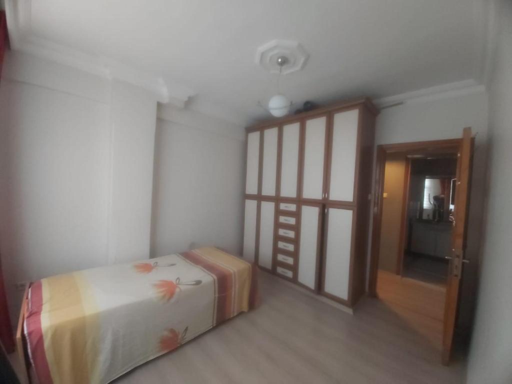 a small room with a bed and a door at Şirinevler meydan daire in Istanbul