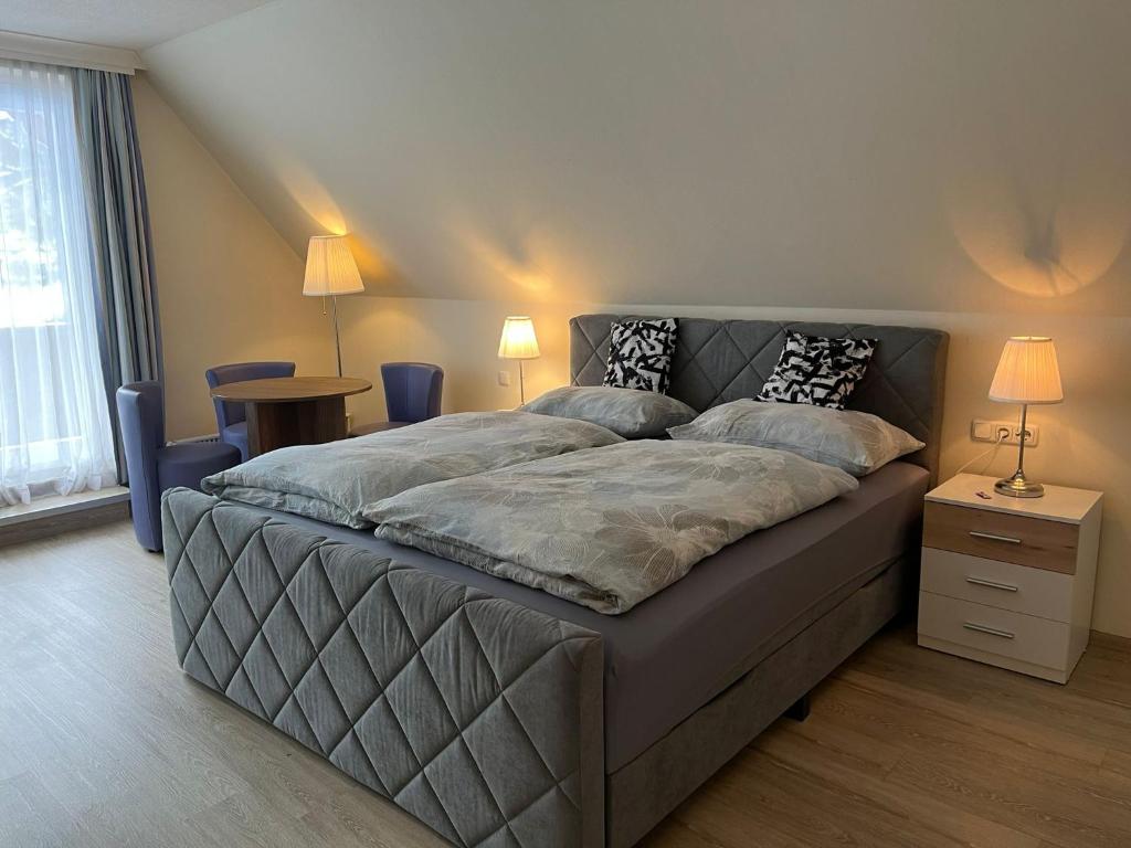 a bedroom with a large bed with two pillows at Gemütliche Wohnung am Golfplatz mit Bergblick in St. Wolfgang