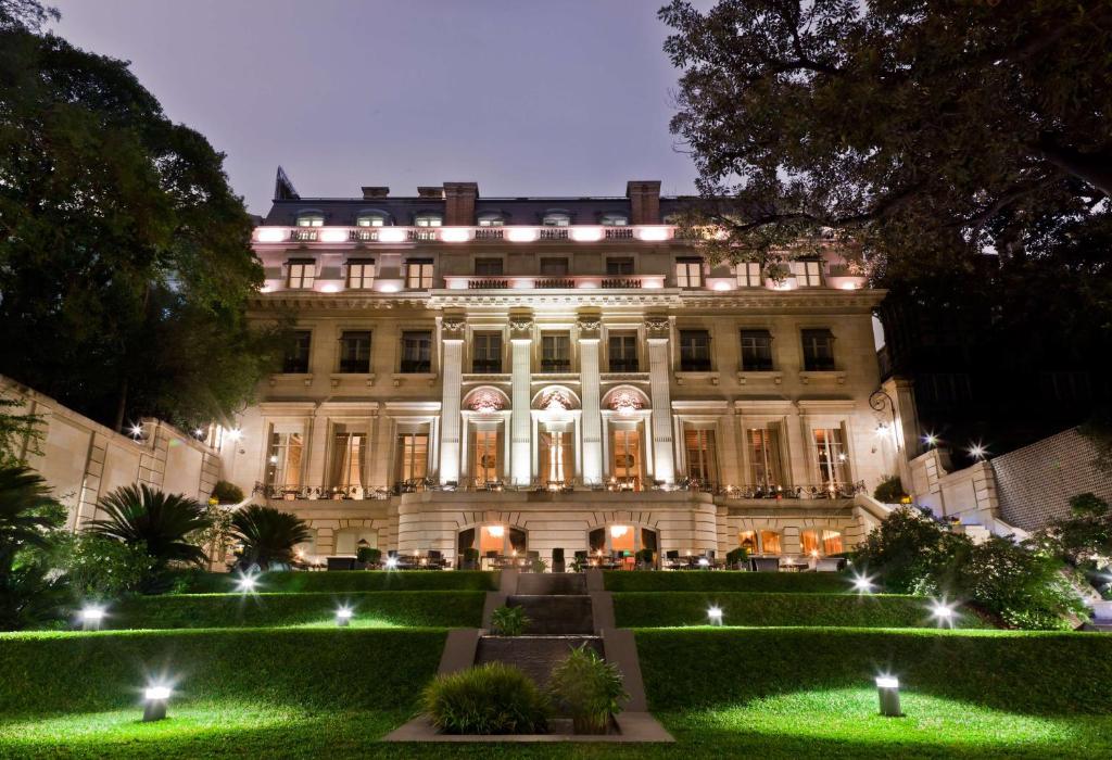 um grande edifício com um jardim em frente em Palacio Duhau - Park Hyatt Buenos Aires em Buenos Aires