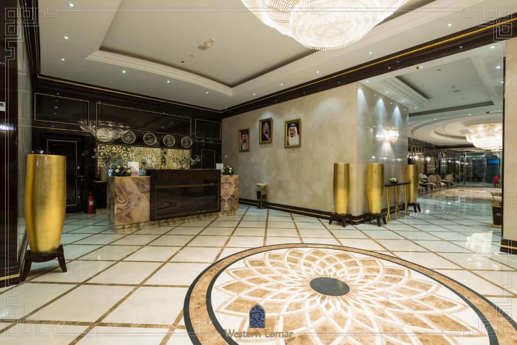 a lobby of a hotel with a table and a counter at Western Lamar Hotel in Jeddah