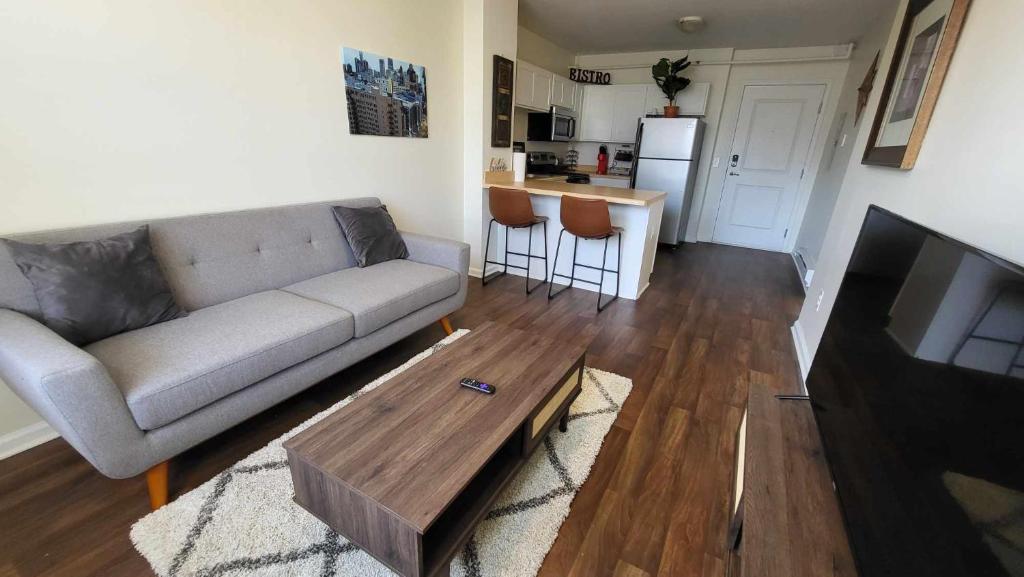 a living room with a couch and a coffee table at Heart of Detroit Gem! 2BR Apt in Detroit