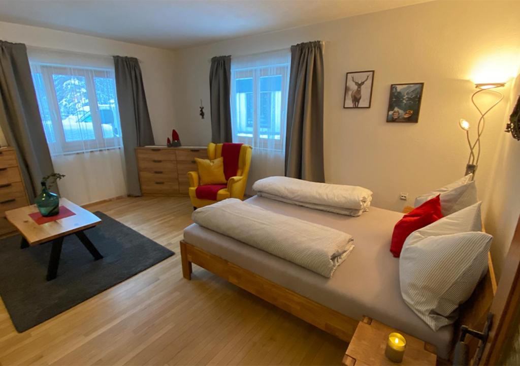 a bedroom with a bed and a living room at Jägers Wohnung zwischen Ehrenberg und Neuschwanstein in Reutte