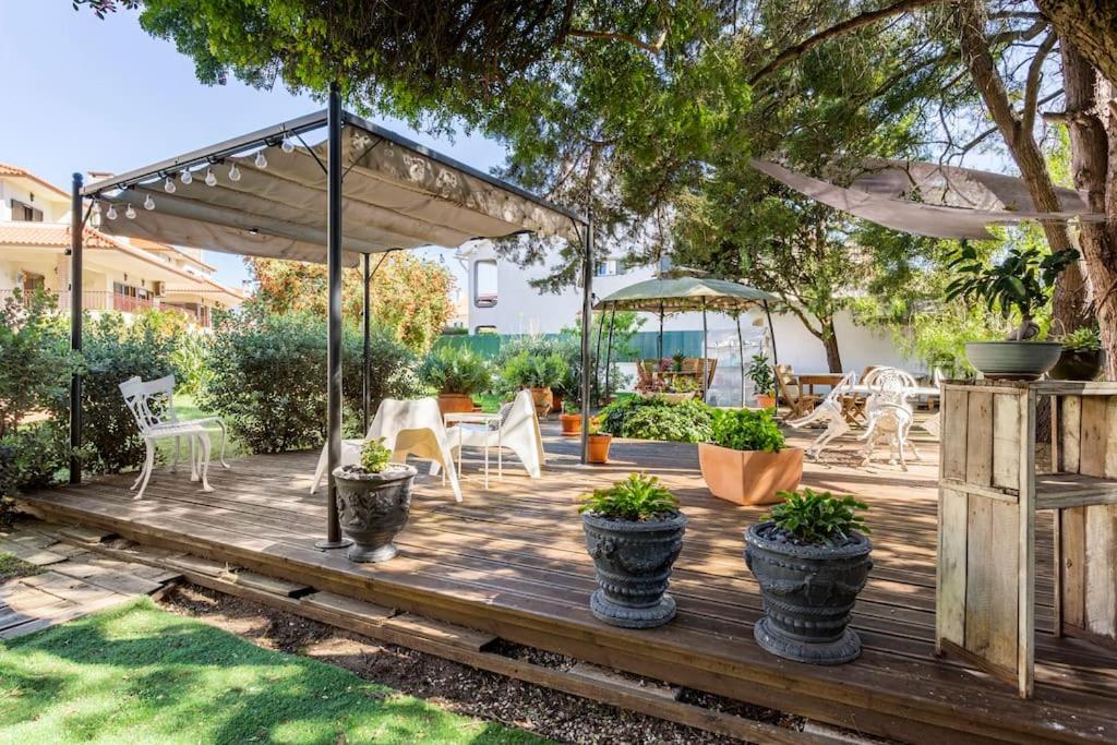 a wooden deck with a table and chairs on it at Paradise Suites in Carcavelos