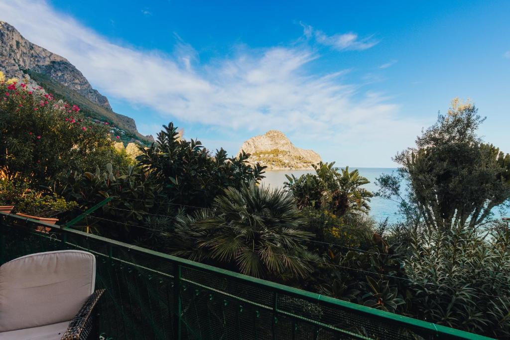 a balcony with a view of the ocean and mountains at Monia beach house in Santa Flavia
