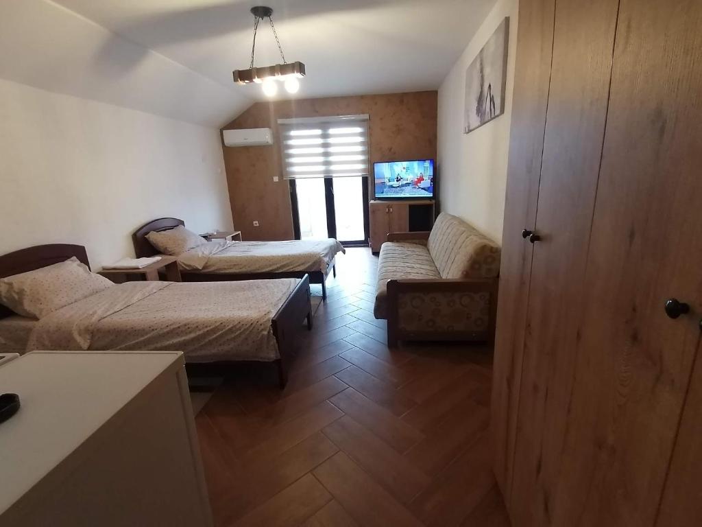 a living room with two beds and a couch at Apartmani Lena in Kraljevo