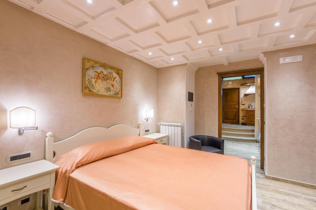 a bedroom with a bed with an orange bedspread at B&B La Casa Nel Giardino in Piano di Sorrento
