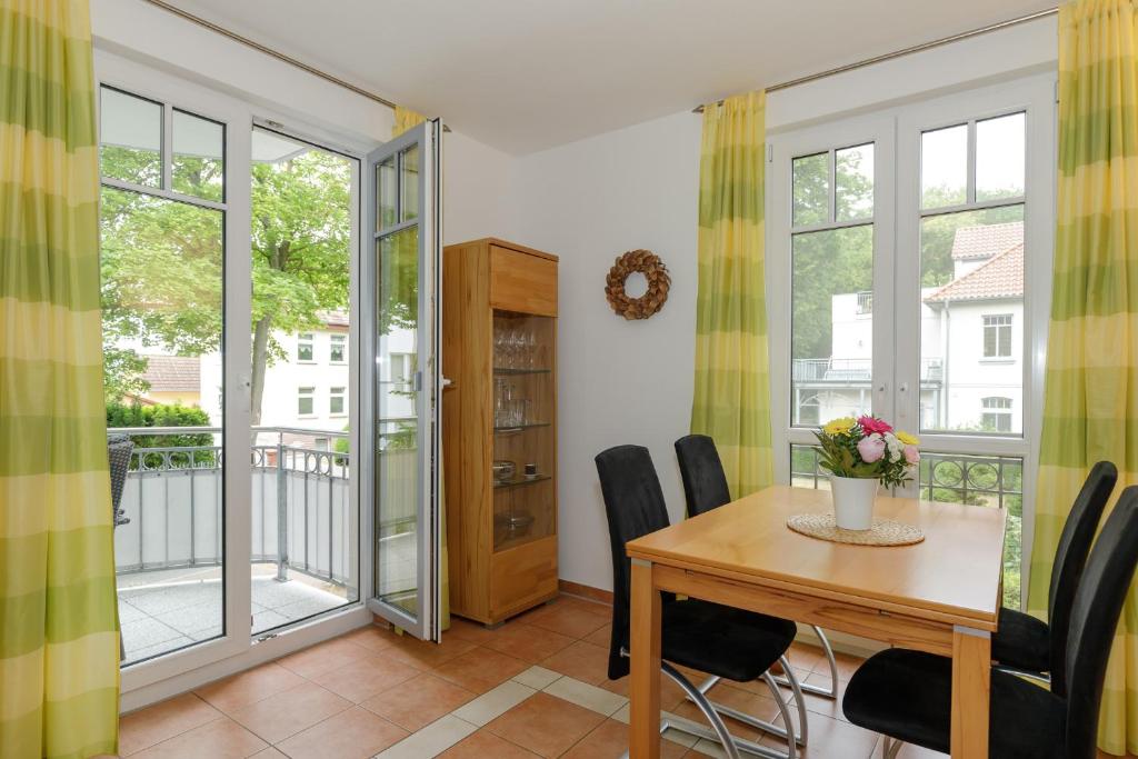 a dining room with a table and chairs at Villa Antonia Whg_ 7 in Rerik