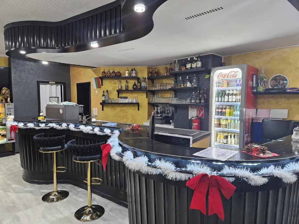 a bar in a restaurant with a coca cola refrigerator at Hotel Annis M&P in Dortmund