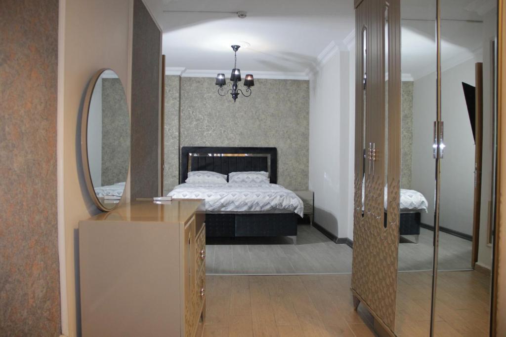 a bedroom with a bed and a mirror at Bomonti Solo Exclusive Designed Hotel in Istanbul
