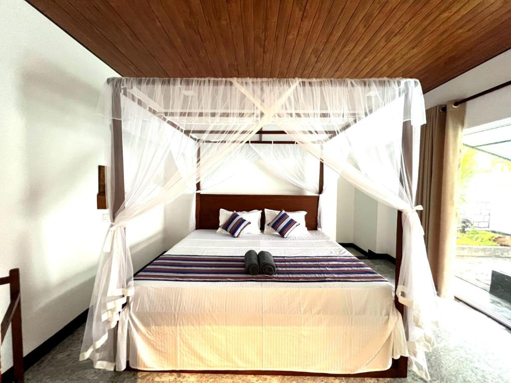 Postel nebo postele na pokoji v ubytování Mango Tree House Mirissa