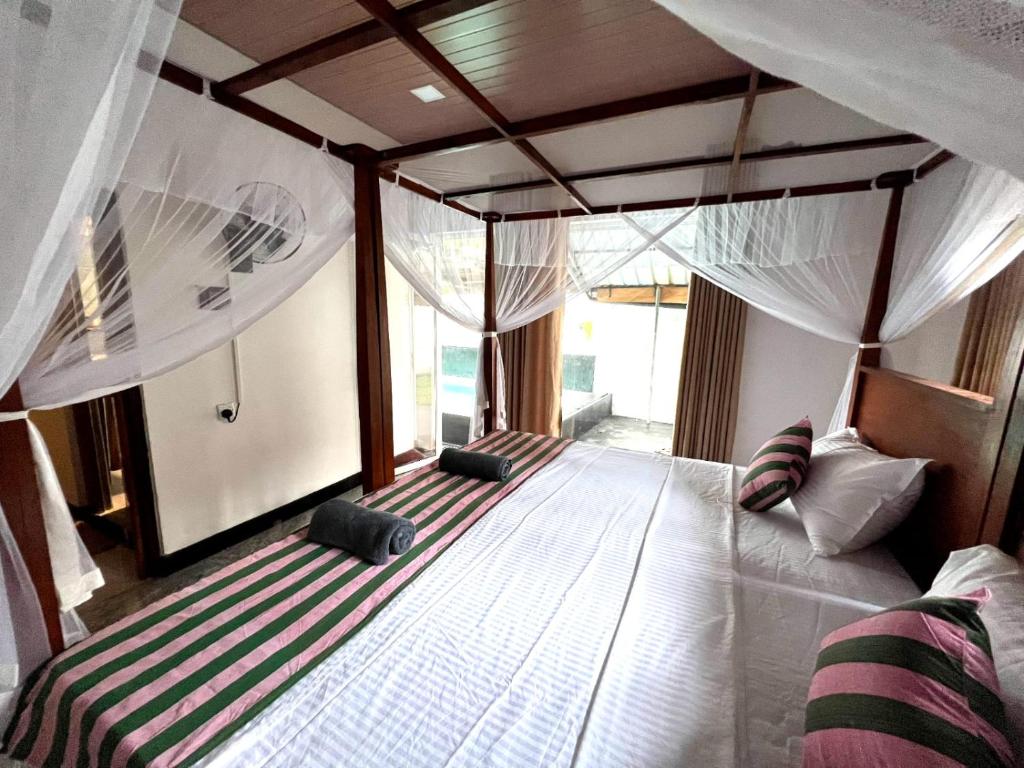 Postel nebo postele na pokoji v ubytování Mango Tree House Mirissa