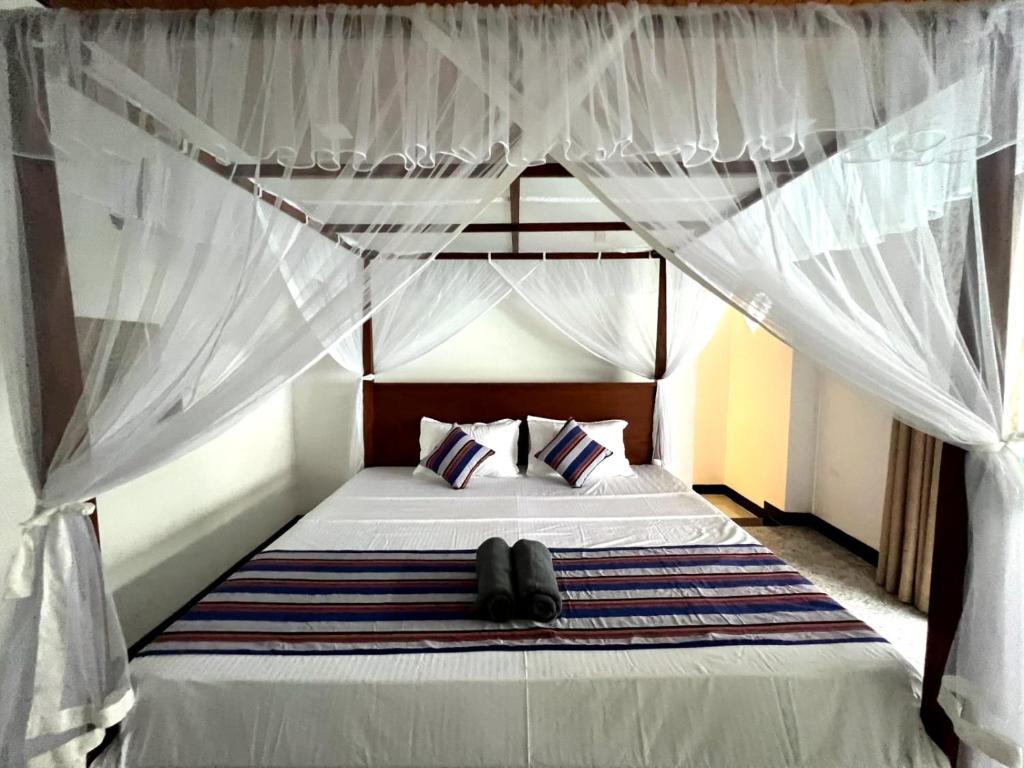 Postel nebo postele na pokoji v ubytování Mango Tree House Mirissa