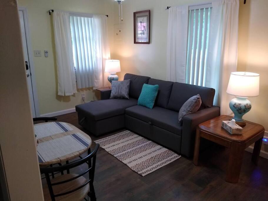 a living room with a couch and a table at Quaint Cabin By The Creek Private in Pipestem