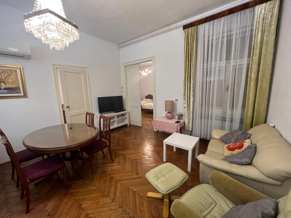 a living room with a couch and a table and a dining room at Apartment Croatia in Zagreb