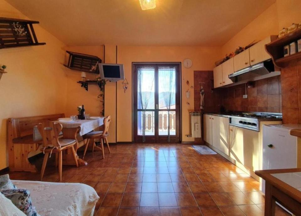 a kitchen with a table and a dining room at Amy House in San Giacomo