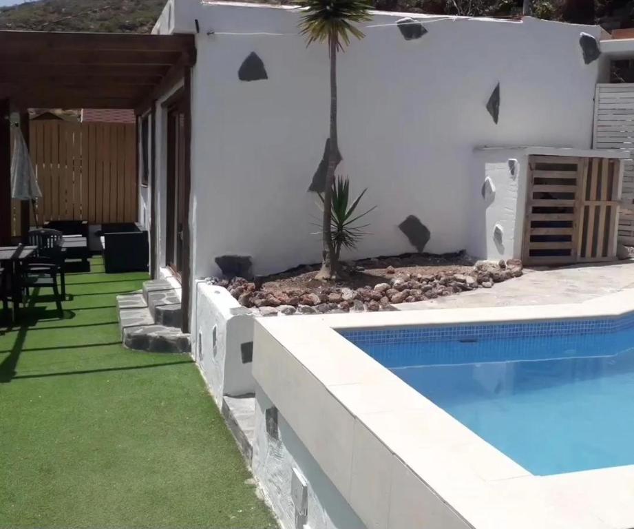 a villa with a swimming pool and a patio at Nueva Casa rural piscina privada in Santa Cruz de Tenerife