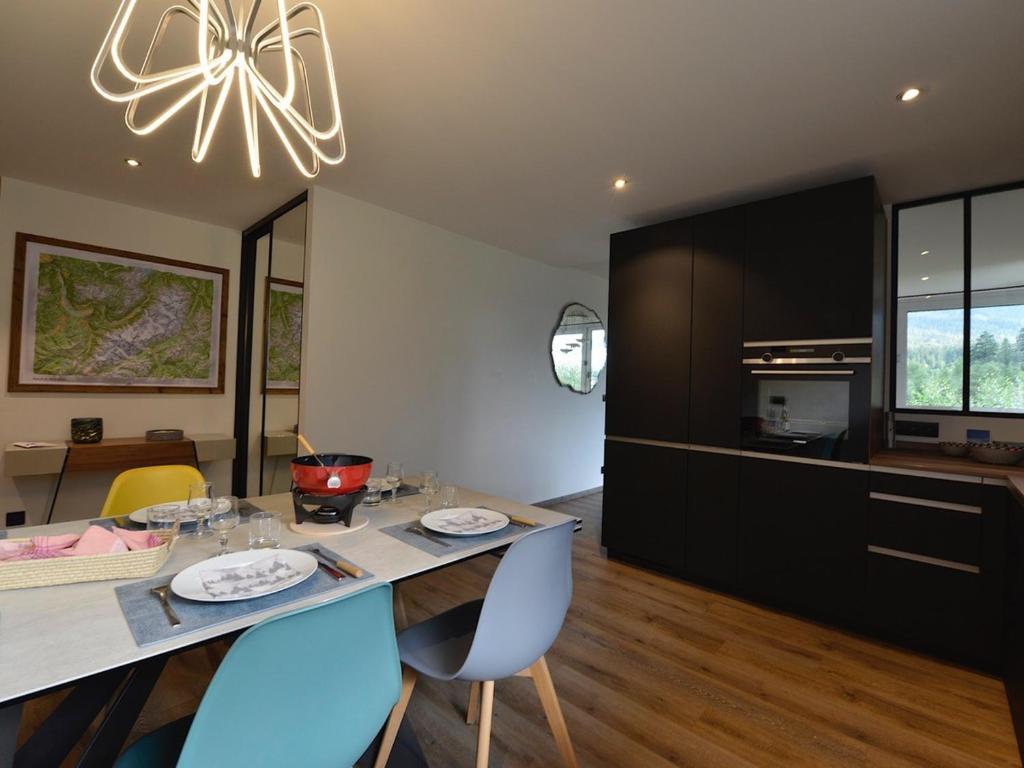a kitchen with a dining table with chairs and a chandelier at Appartement Chamonix-Mont-Blanc, 4 pièces, 6 personnes - FR-1-507-62 in Chamonix