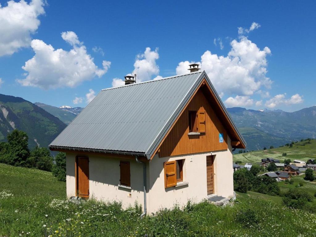 a small house with a tin roof on a hill at Chalet Albiez-Montrond, 4 pièces, 8 personnes - FR-1-618-16 in Albiez-Montrond