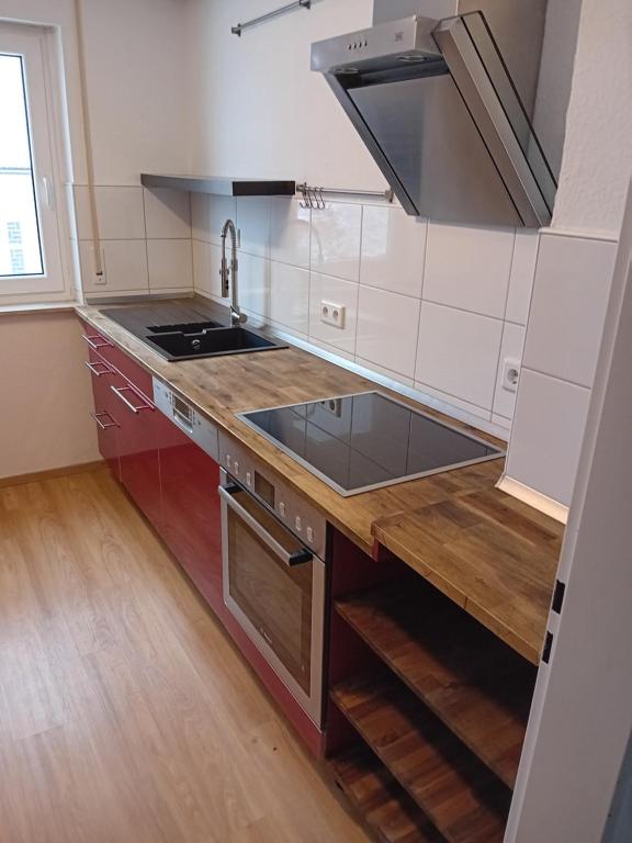 a kitchen with a sink and a stove top oven at Geräumige FeWo nahe Nürnberg in Oberasbach