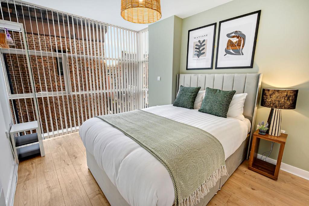 a bedroom with a large bed and a window at Host & Stay - The Skandi Hideaway in Liverpool