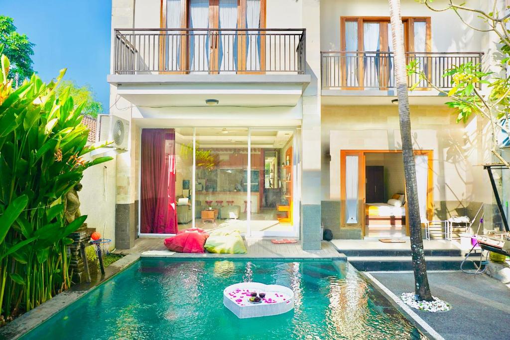 a house with a swimming pool in front of a house at Private 3- bedroom Villa with pool. in Kuta