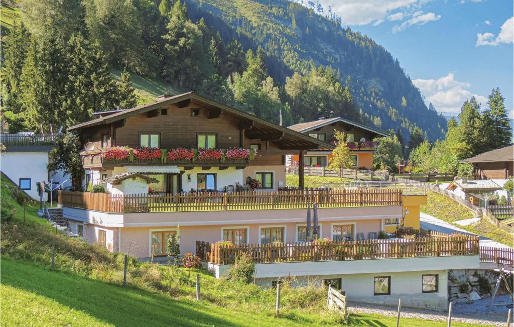 a large house with a balcony on a hill at Beautiful Apartment In Rauris With 4 Bedrooms And Internet in Rauris