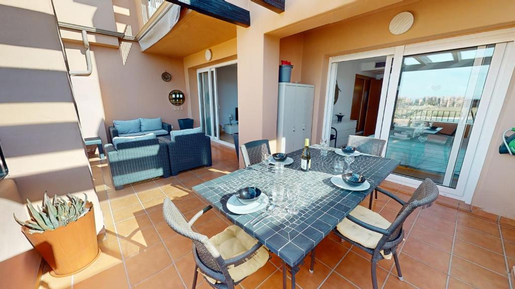a dining table and chairs in a living room at Casa Espliego V-A Murcia Holiday Rentals Property in Torre-Pacheco